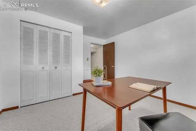a view of a room that has a table and chairs in it