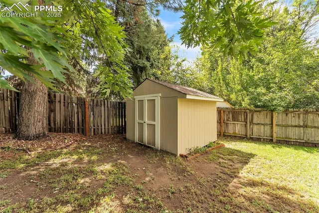 a view of a backyard with a garden and entertaining space