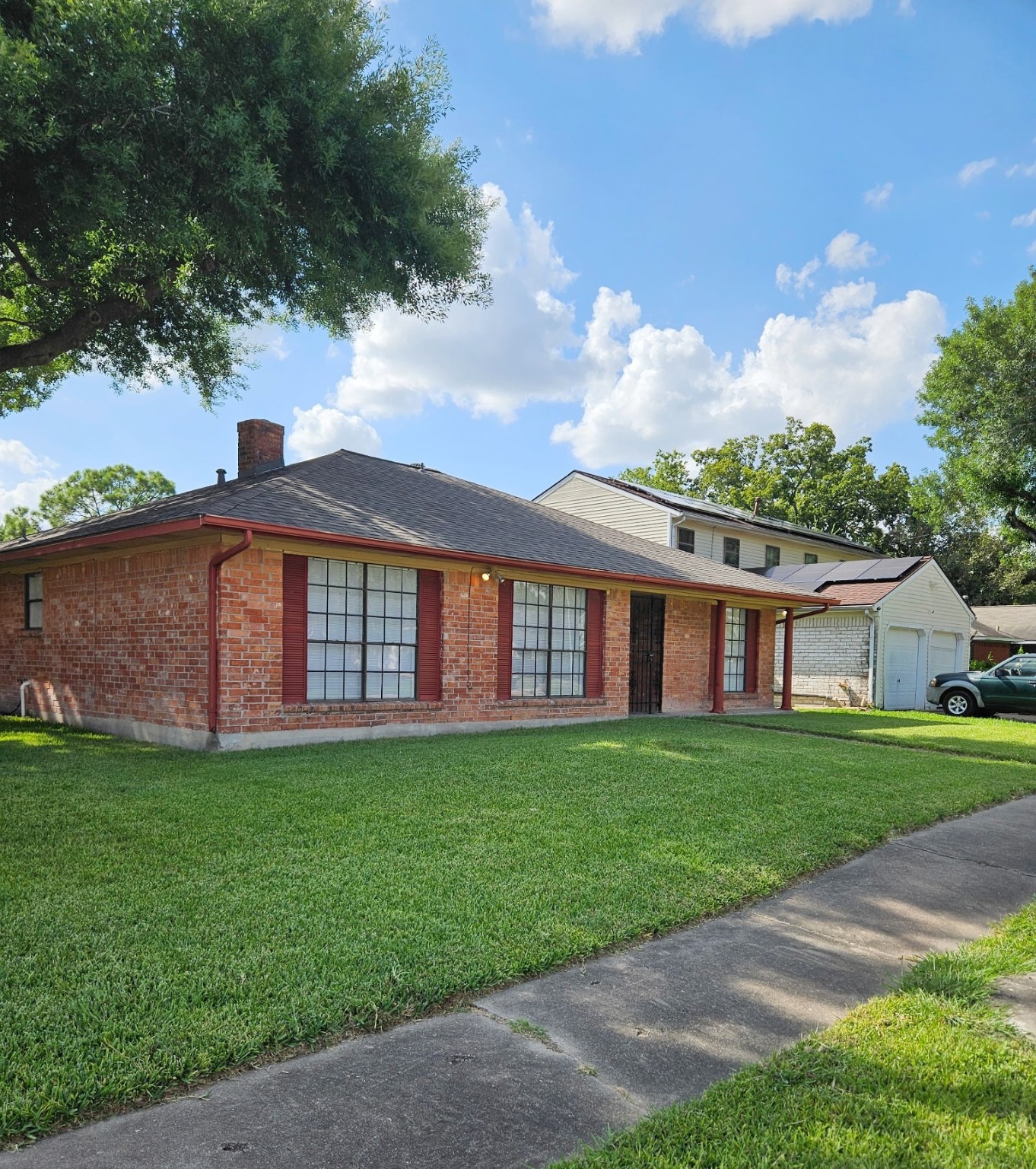7206 Navidad Road Houston, TX 77083 - Photo 1 of 48 a large brick building with a yard in front of it