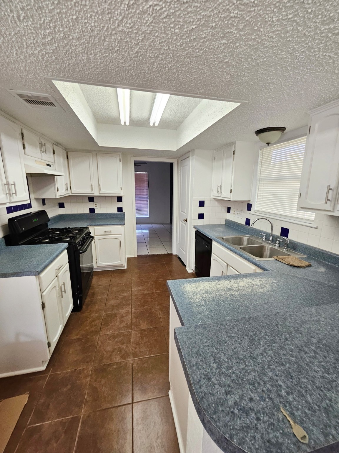 7206 Navidad Road Houston, TX 77083 - Photo 20 of 48 a large kitchen with kitchen island a sink a counter top space and cabinets