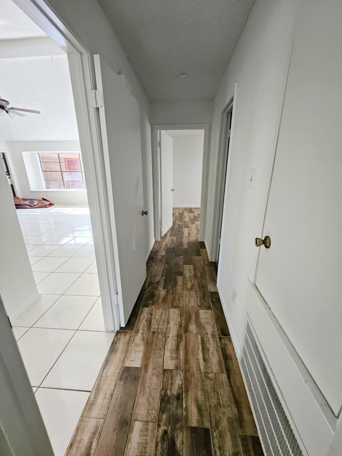 7206 Navidad Road Houston, TX 77083 - Photo 35 of 48 a view of a hallway with wooden floor and staircase