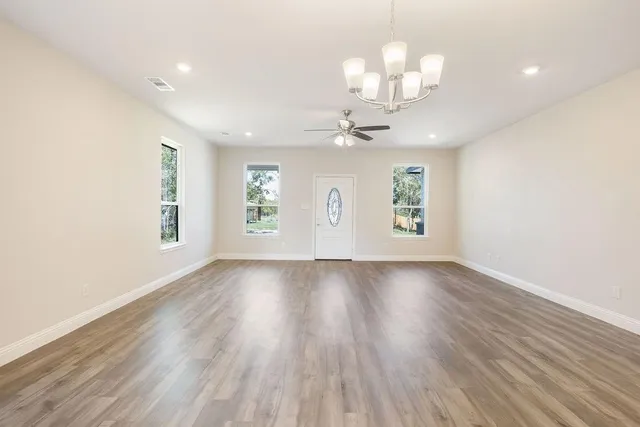 wooden floor in an empty room with a window