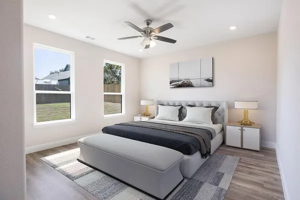 a bedroom with a large bed and a window