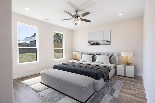 a bedroom with a large bed and a window