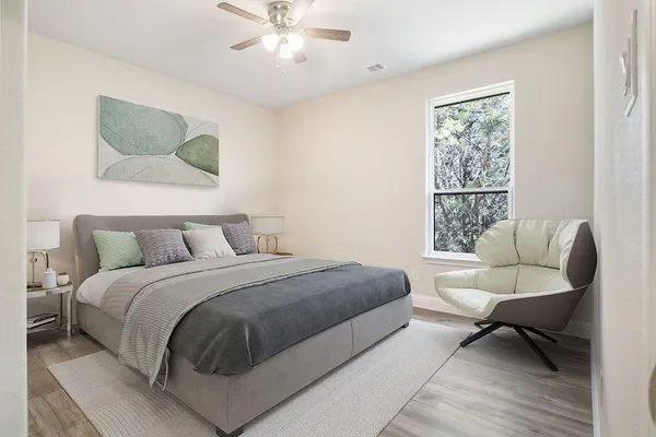 a bedroom with a large bed couch and a window
