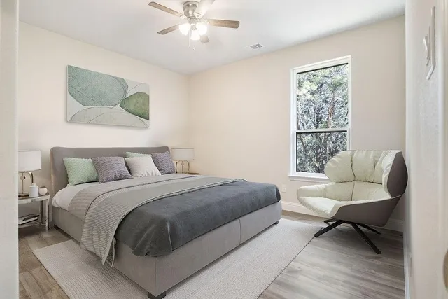 a bedroom with a large bed couch and a window