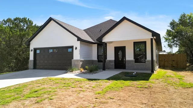 a front view of a house with a yard and garage