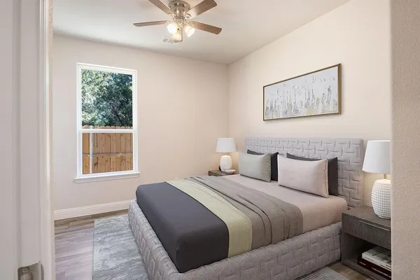 a bedroom with a bed and a window