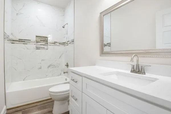 a bathroom with a sink a toilet and a bathtub