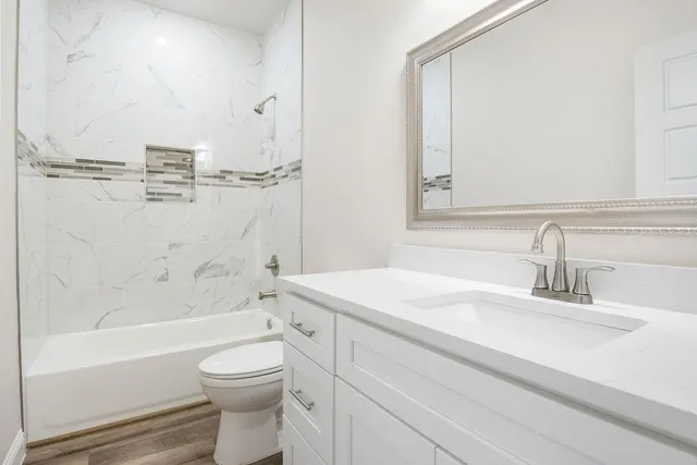 a bathroom with a sink a toilet and a bathtub