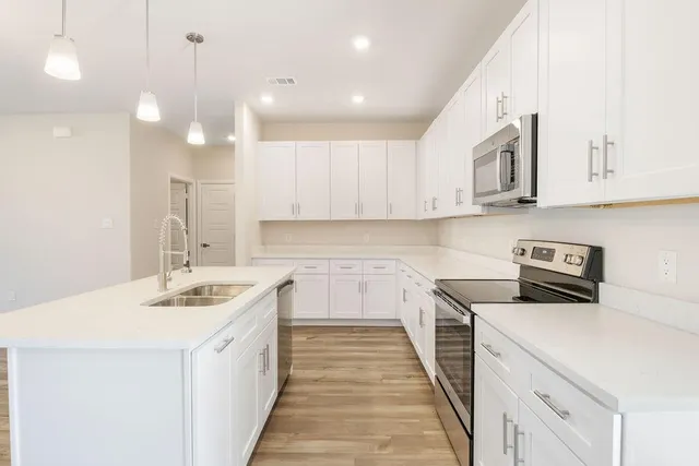a kitchen with a sink stove and refrigerator