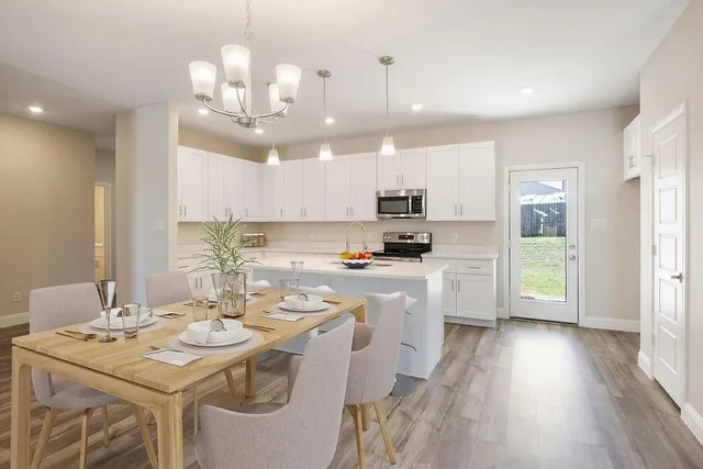 a kitchen with stainless steel appliances kitchen island granite countertop a sink and cabinets