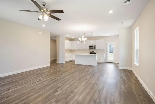 a view of a kitchen with a white cabinet and a stove top oven