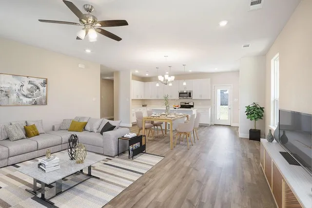 a living room with furniture and a chandelier