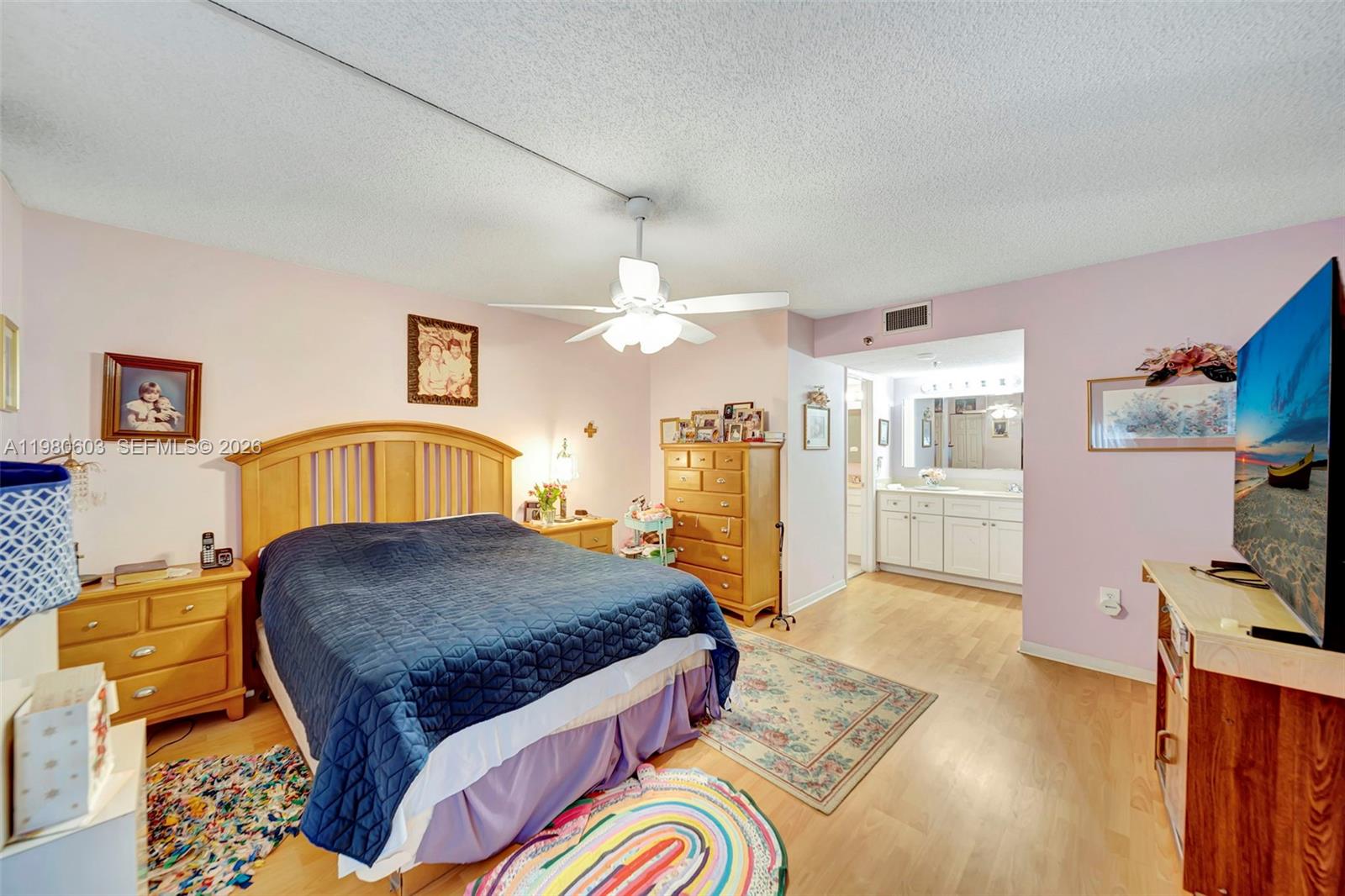 3940 Inverrary Boulevard, Unit 303A Lauderhill, FL 33319 - Photo 11 of 28 a spacious bedroom with a bed a flat screen tv and dresser