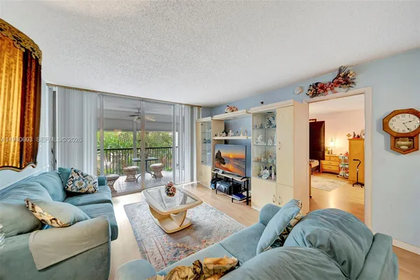 a living room with furniture and a large window