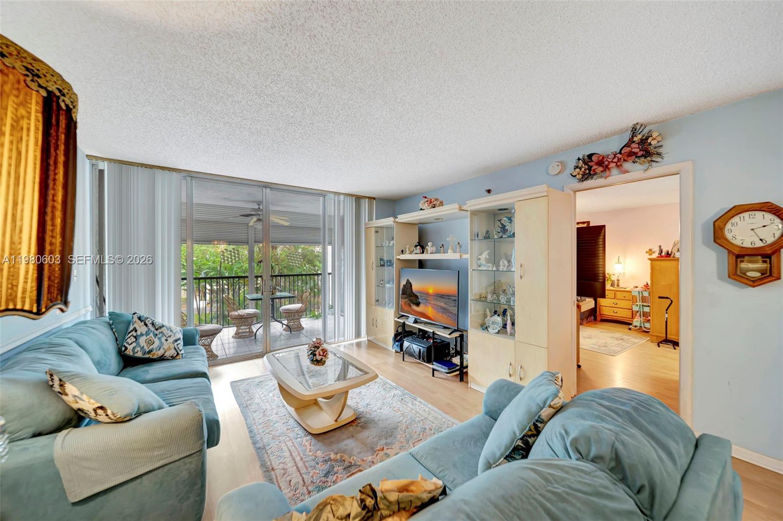 3940 Inverrary Boulevard, Unit 303A Lauderhill, FL 33319 - Photo 5 of 28 a living room with furniture and a large window