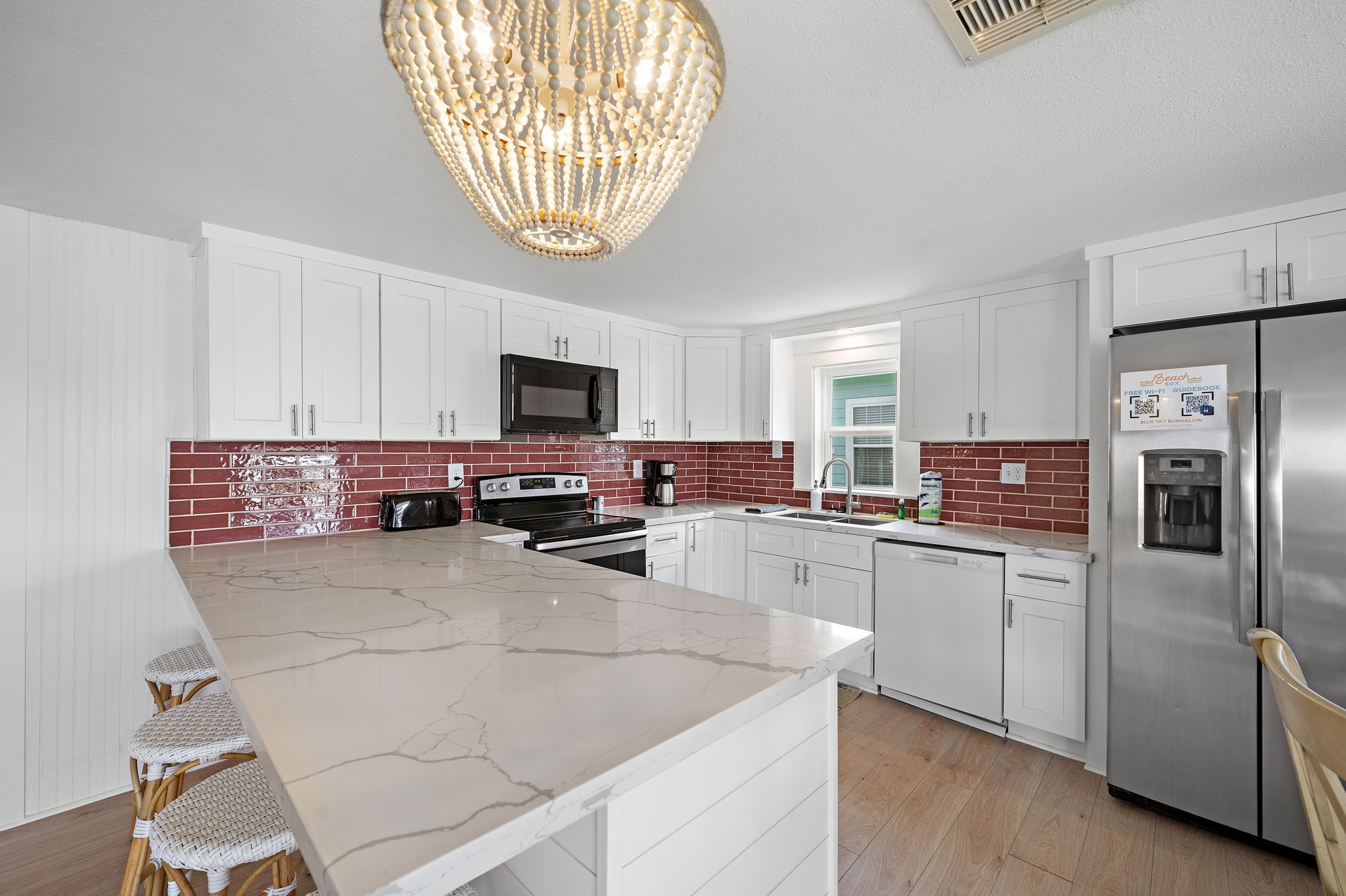 417 Olive Street Surfside Beach, TX 77541 - Photo 12 of 46 a kitchen with stainless steel appliances a refrigerator sink and microwave
