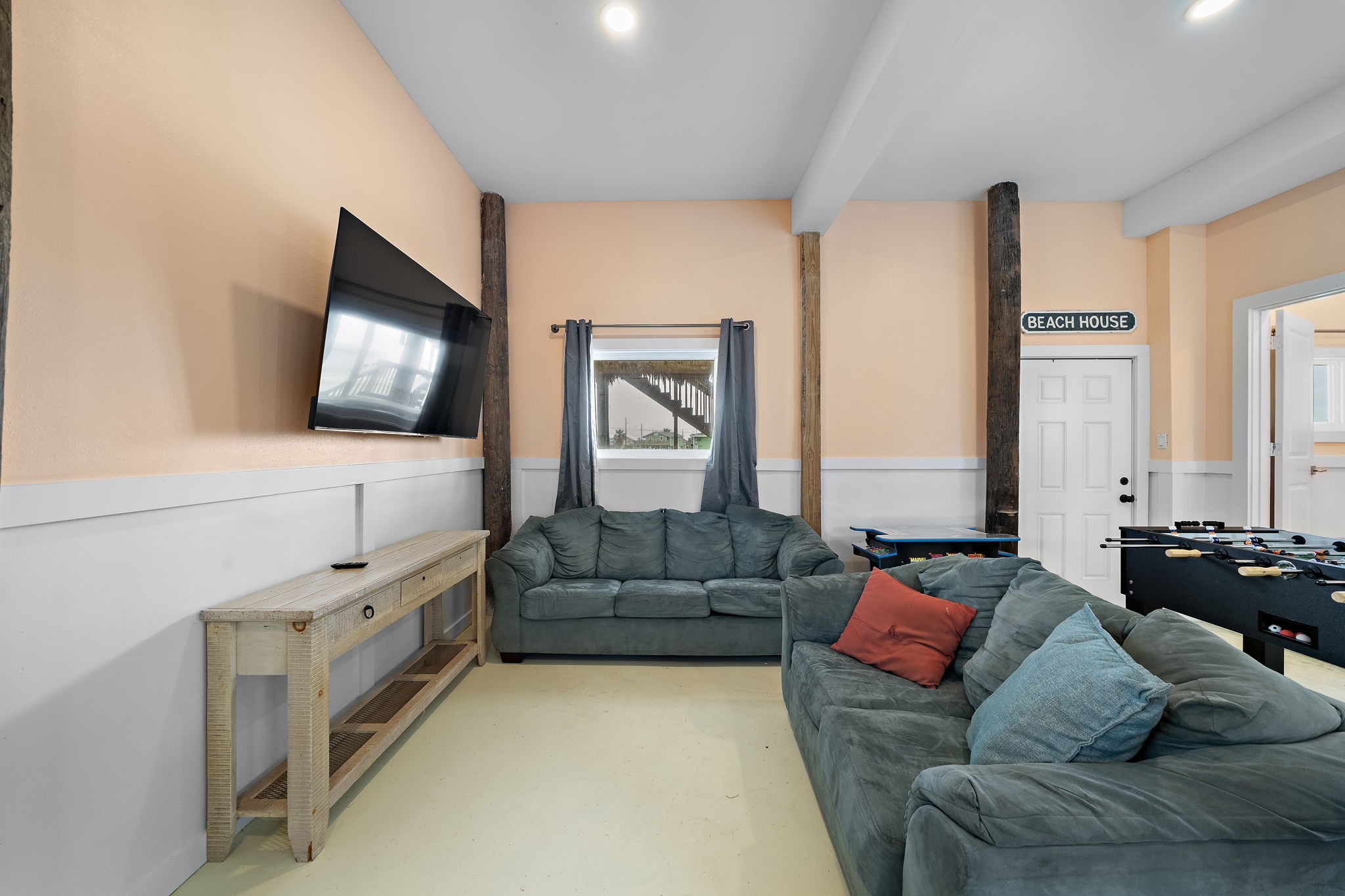 417 Olive Street Surfside Beach, TX 77541 - Photo 34 of 46 a living room with furniture and a flat screen tv