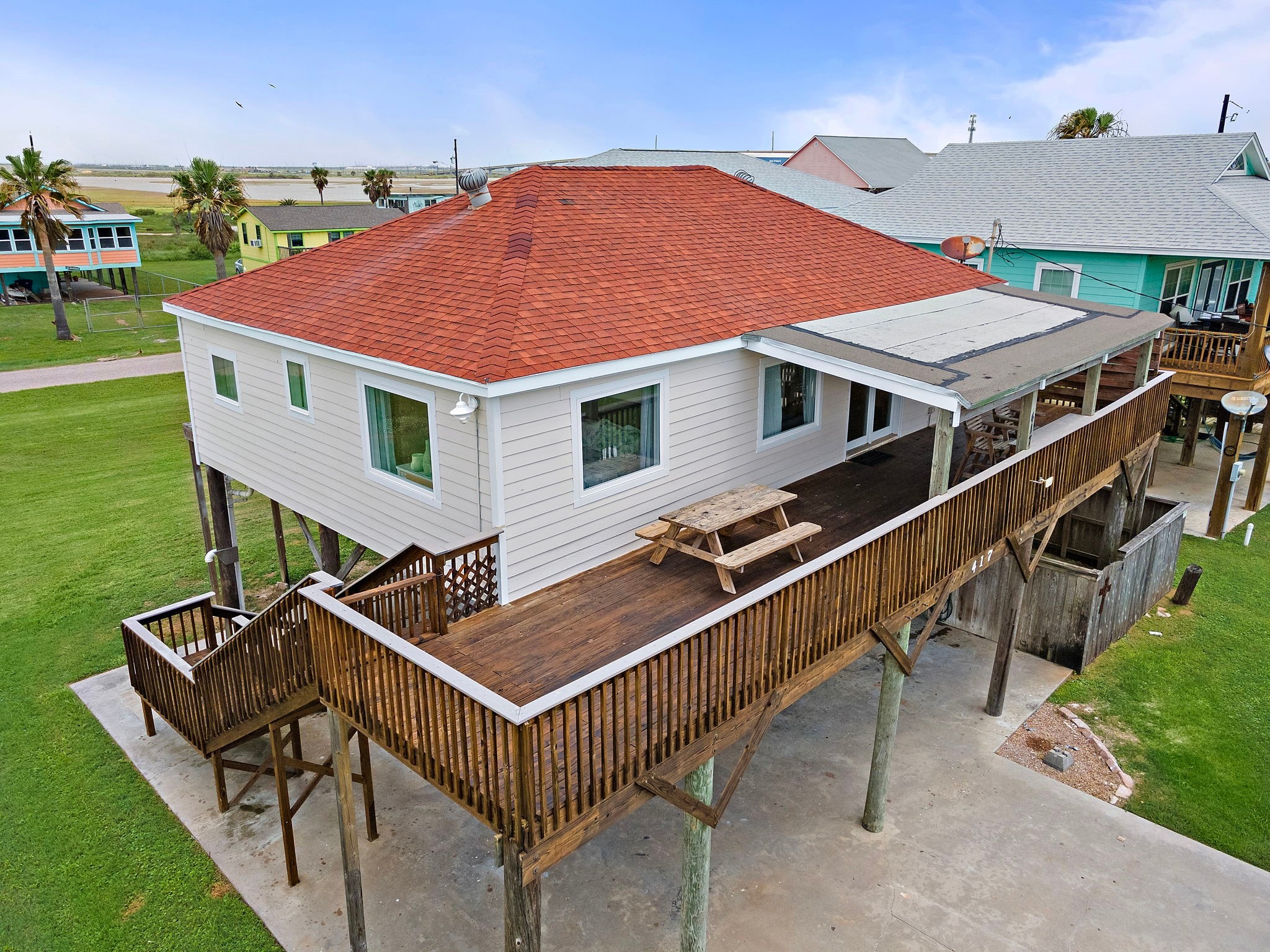 417 Olive Street Surfside Beach, TX 77541 - Photo 41 of 46 a roof deck with a yard table and chairs
