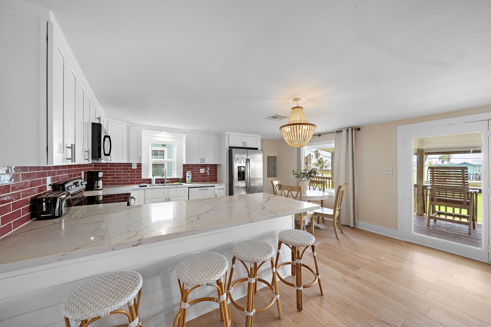 417 Olive Street Surfside Beach, TX 77541 - Photo 10 of 46 a view of a dining room with furniture and wooden floor