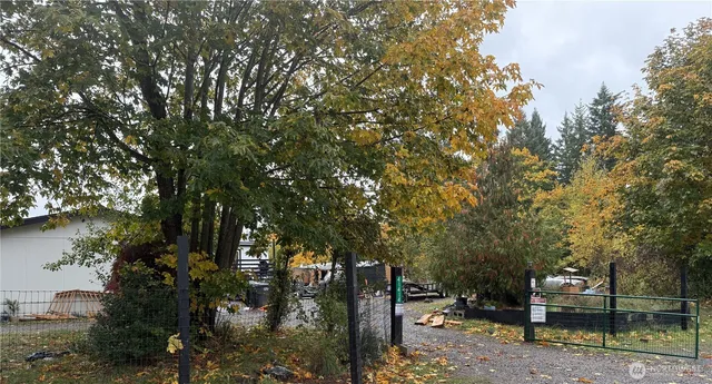 a backyard of a house with lots of green space and fountain