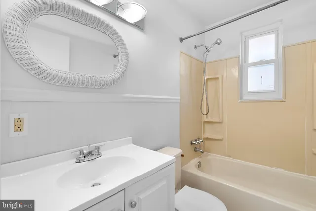 a bathroom with a sink a toilet and bathtub