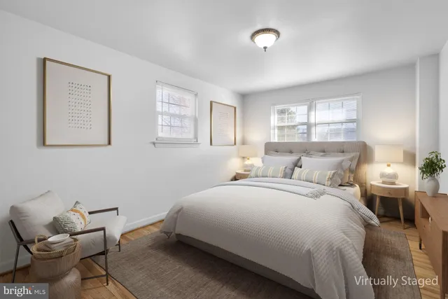 a bedroom with a bed and windows