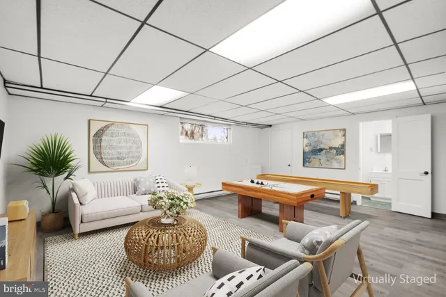 a living room with furniture a table and a potted plant