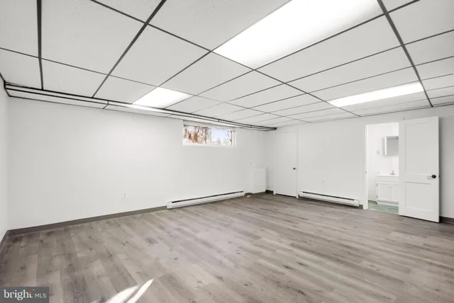 a view of a room with wooden floor