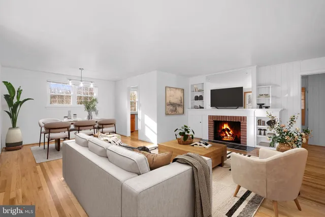 a living room with furniture a fireplace and a flat screen tv