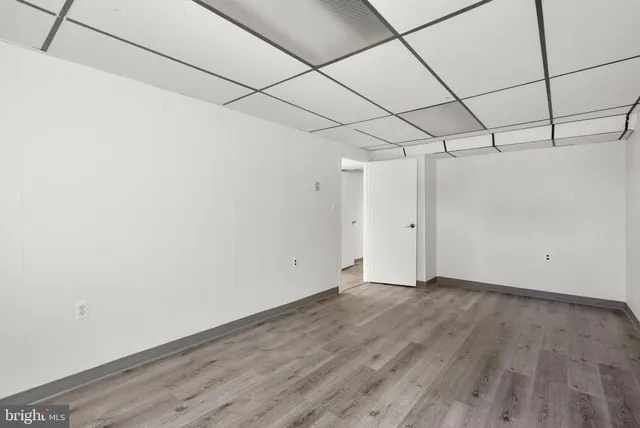 a view of a room with wooden floor