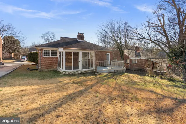 a front view of a house with a yard covered with snow