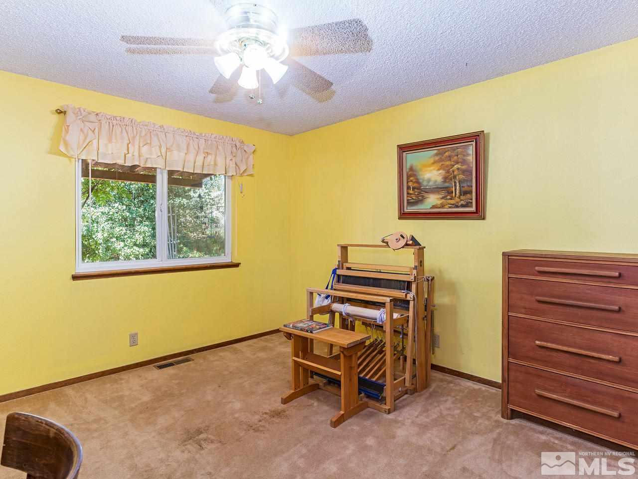 13055 Thomas Creek Road Reno, NV 89511 - Photo 14 of 24 a bedroom with a bed and a window