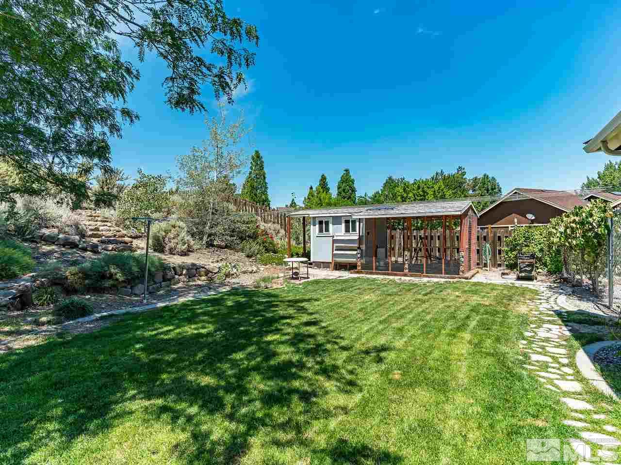 13055 Thomas Creek Road Reno, NV 89511 - Photo 20 of 24 a front view of a house with a garden