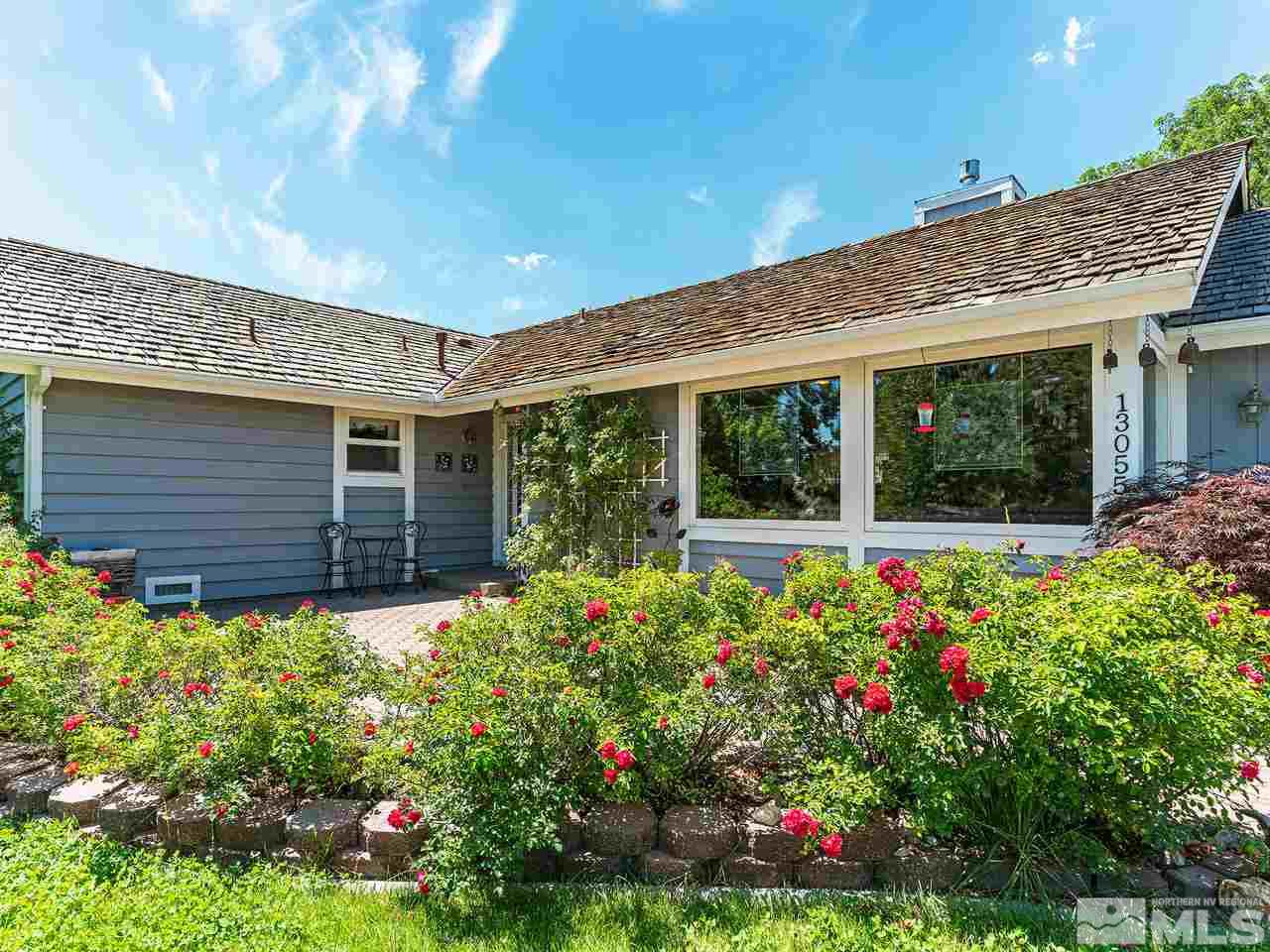 13055 Thomas Creek Road Reno, NV 89511 - Photo 2 of 24 a view of a house with a flower garden