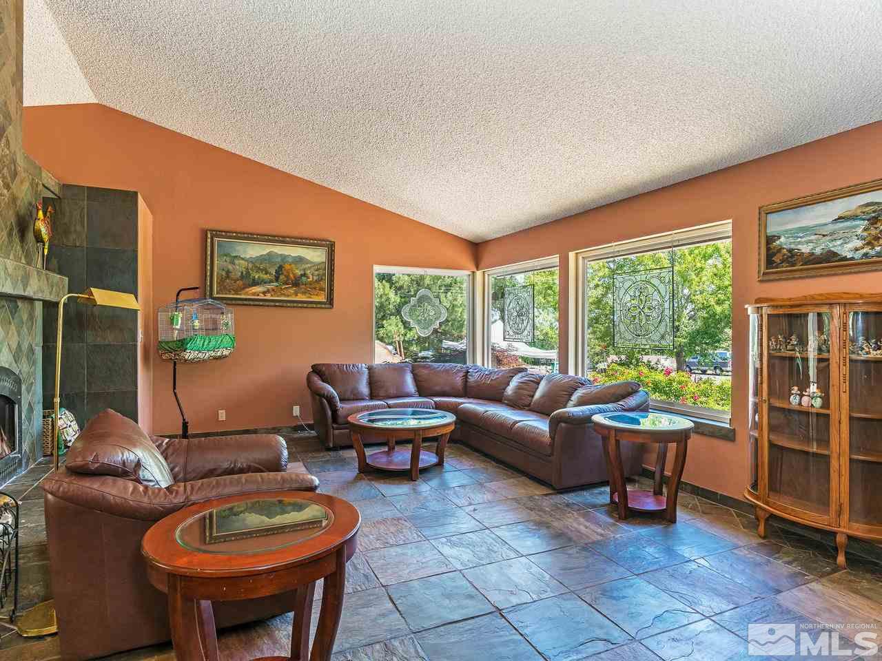 13055 Thomas Creek Road Reno, NV 89511 - Photo 3 of 24 a living room with furniture a rug a lamp and a large window