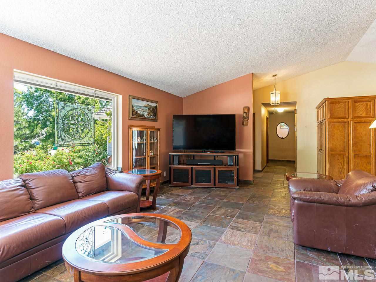 13055 Thomas Creek Road Reno, NV 89511 - Photo 5 of 24 a living room with furniture and a flat screen tv