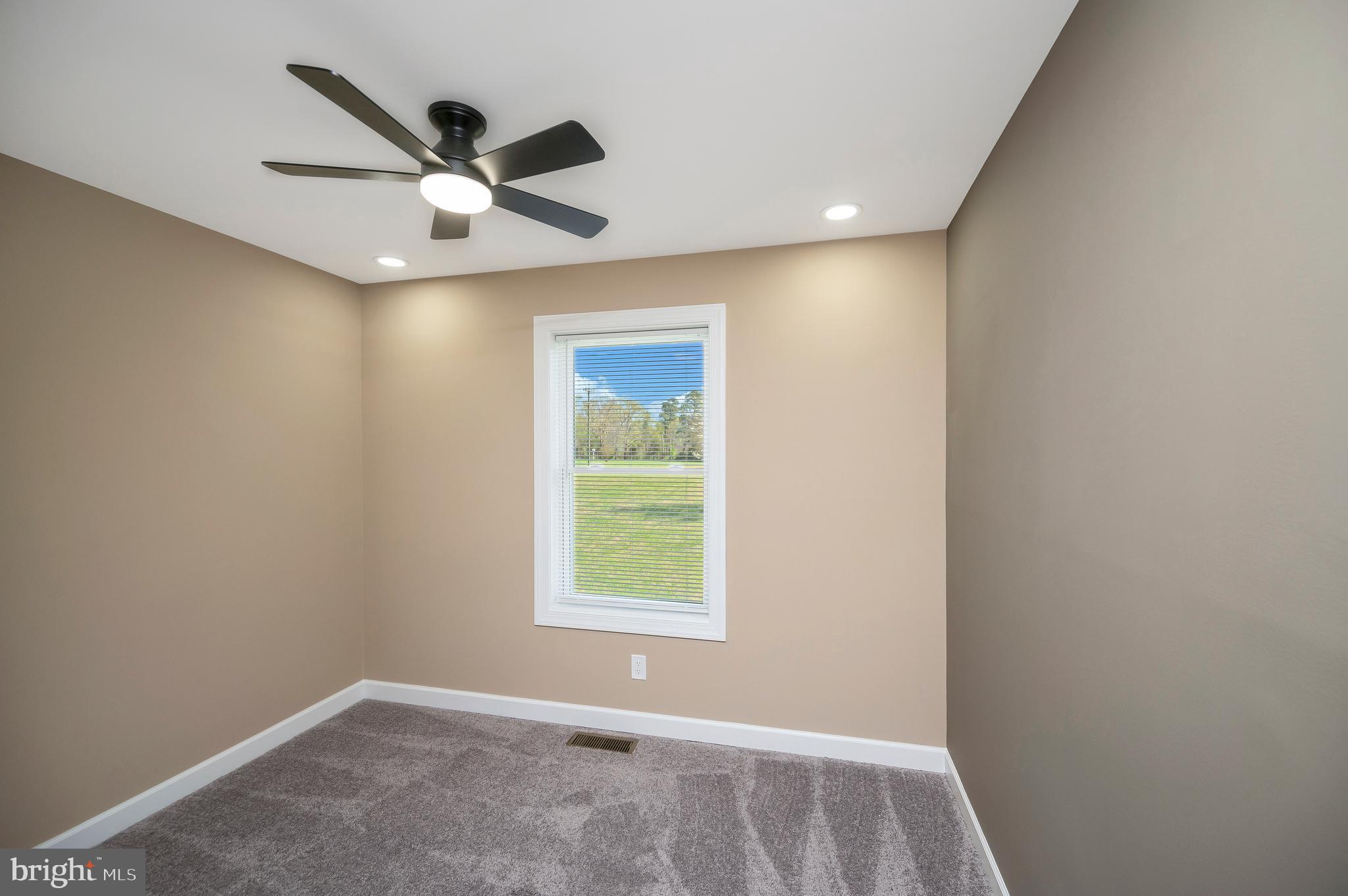 13452 Post Oak Road Spotsylvania, VA 22551 - Photo 39 of 56 an empty room with a window and a ceiling fan