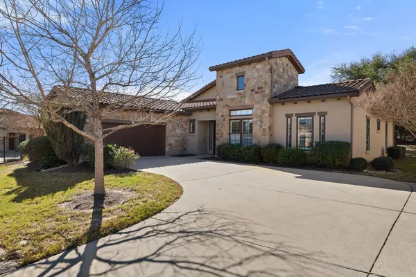 a kitchen with stainless steel appliances wooden cabinets a stove a sink a microwave and a refrigerator