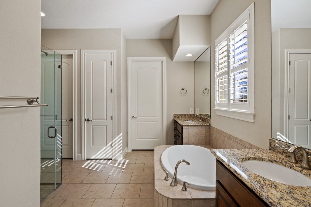404 Amiata Avenue, Unit 34 Austin, TX 78734 - Photo 14 of 26 a bathroom with a granite countertop sink toilet and shower