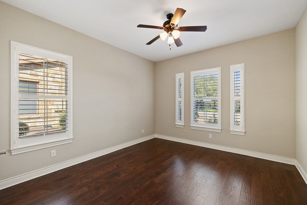 404 Amiata Avenue, Unit 34 Austin, TX 78734 - Photo 17 of 26 a view of an empty room with wooden floor and a window