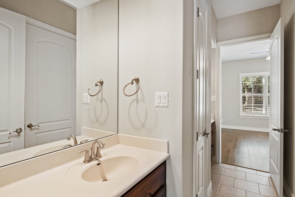 404 Amiata Avenue, Unit 34 Austin, TX 78734 - Photo 18 of 26 a bathroom with a sink and a mirror