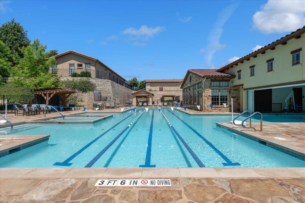404 Amiata Avenue, Unit 34 Austin, TX 78734 - Photo 25 of 26 a view of swimming pool with outdoor seating and house in the background