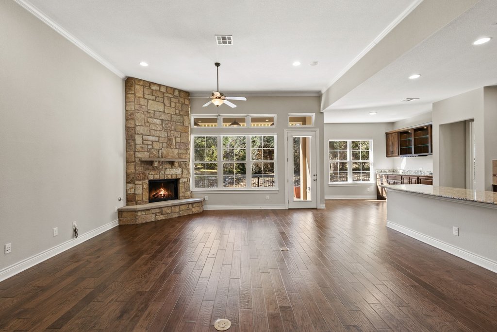 404 Amiata Avenue, Unit 34 Austin, TX 78734 - Photo 4 of 26 an empty room with wooden floor and fireplace