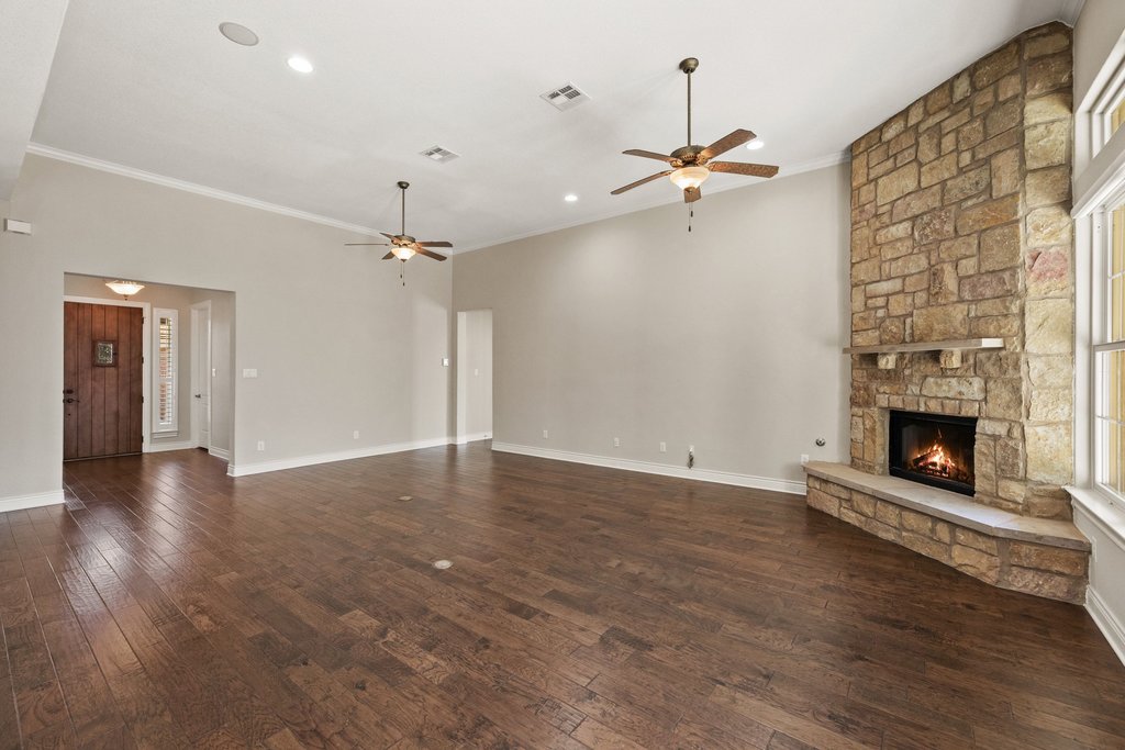 404 Amiata Avenue, Unit 34 Austin, TX 78734 - Photo 9 of 26 wooden floor in an empty room with a fireplace