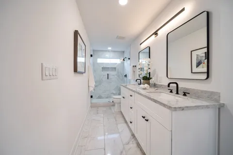 a bathroom with a granite countertop sink mirror and a