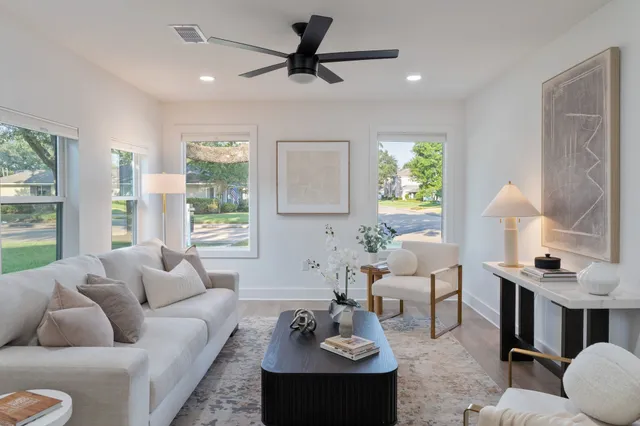 a living room with furniture fireplace and a large window