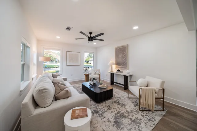 a living room with furniture and a large window