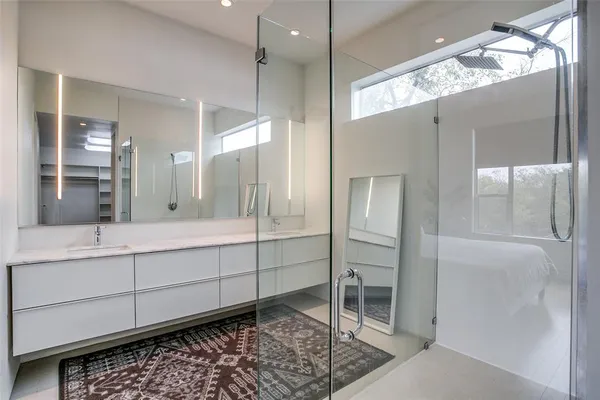 a bathroom with a double vanity sink and a mirror